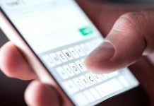 A man texting on a mobile phone. (Stock photo)