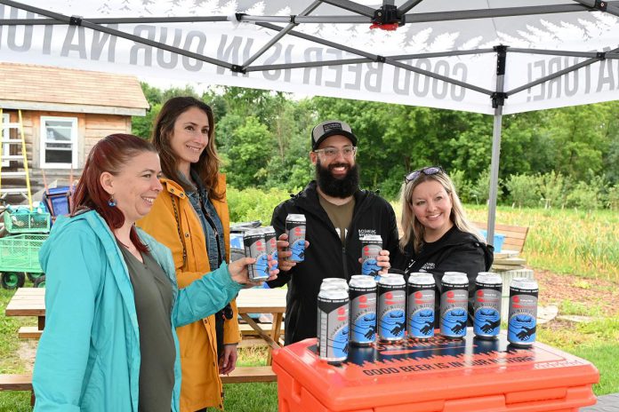 The United Way City of Kawartha Lakes (United Way CKL) and Minden's Boshkung Brewing Company are partnering to raise money for United Way CKL through sales of a new beer called "Paddle with Purpose." Pictured are United Way CKL co-executive director Emily Beall (second from left) and Boshkung Brewing Company owner Mathew Renda (second from right) at the beer launch in Lindsay on July 10, 2024. (Photo: United Way CKL)