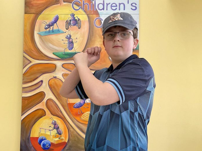 William, a Five Counties client, strikes a batting stance to illustrate his love for baseball. For William, this represents "Fun," which is one of the six F-words of child development. (Photo: Five Counties Children's Centre)