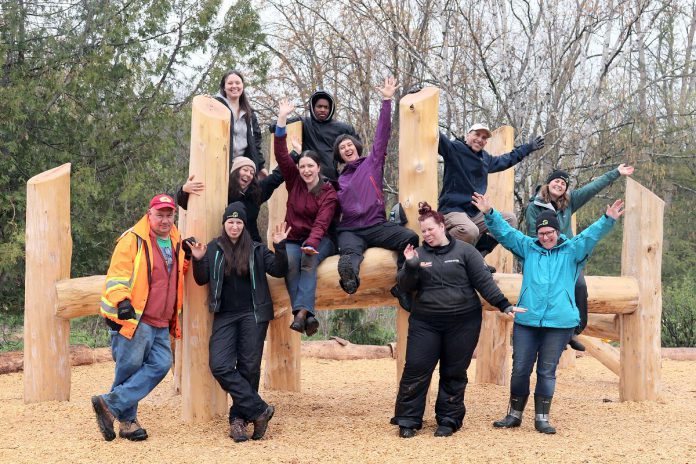 GreenUP staff gathers to celebrate Peterborough's first naturalized playscape in the children's garden in Ecology Park in 2023. The construction of the playscape fulfilled a deliverable in GreenUP's previous strategic plan. (Photo: Lili Paradi / GreenUP)