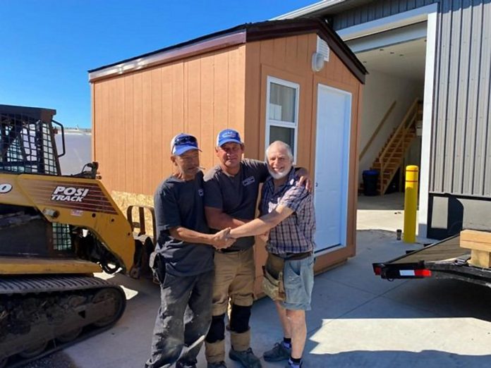 In 2022, grass-roots organization Peterborough Action for Tiny Homes (PATH) revealed a prototype sleeping cabin, which was built by Cleary Homes and a volunteer construction crew with materials supplied at cost by Merrett Home Hardware and Charlotte Paint and Wallpaper and funding raised by Grace United Church. From left to right: Rudy Verhoeven, Chris Cleary of Cleary Homes, and Ross Allen of Grace United Church. (Photo: Peterborough Action for Tiny Homes)