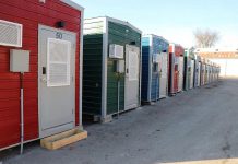 Within six months in 2023, the City of Peterborough constructed 50 modular homes, along with shared washroom facilities and a central service hub, to help end a tent encampment at the same location by providing people experiencing homelessness with the option to stay in the homes. (Photo: City of Peterborough)