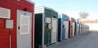 Within six months in 2023, the City of Peterborough constructed 50 modular homes, along with shared washroom facilities and a central service hub, to help end a tent encampment at the same location by providing people experiencing homelessness with the option to stay in the homes. (Photo: City of Peterborough)