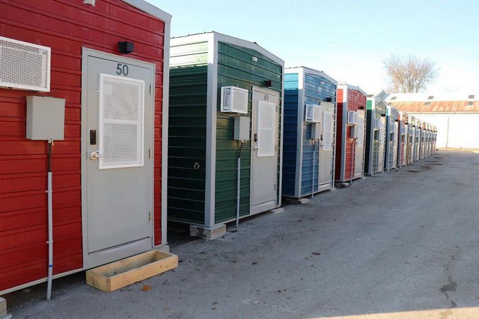 Within six months in 2023, the City of Peterborough constructed 50 modular homes, along with shared washroom facilities and a central service hub, to help end a tent encampment at the same location by providing people experiencing homelessness with the option to stay in the homes. (Photo: City of Peterborough)