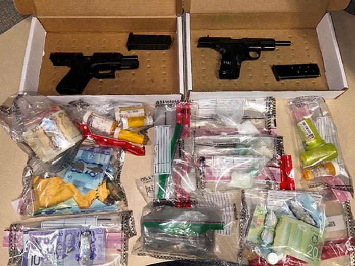 Peterborough police have charged three people with drugs and weapons offences after seizing two loaded handguns, 177 grams of fentanyl, 55 grams of cocaine, 122 Dilaudid pills (hydromorphone), and over $3,000 in Canadian currency during a search of a Peterborough residence on August 9, 2024. (Police-supplied photo)