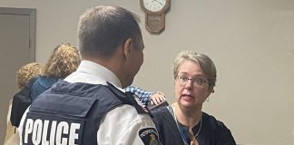 Peterborough Police Service Staff Sergeant Mark Reesor listens to an Ashburnham Ward resident following a public meeting on community safety at the Peterborough Lions Community Centre in East City on September 11, 2024. (Photo: Paul Rellinger / kawarthaNOW)