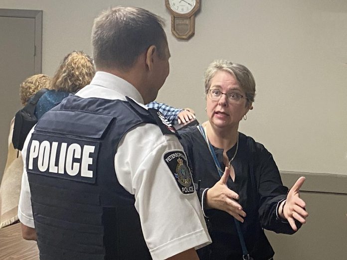 Peterborough Police Service Staff Sergeant Mark Reesor listens to an Ashburnham Ward resident following a public meeting on community safety at the Peterborough Lions Community Centre in East City on September 11, 2024. (Photo: Paul Rellinger / kawarthaNOW)