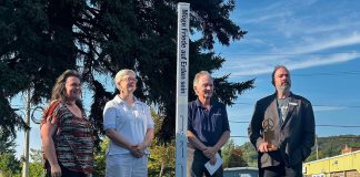 From right to left: Bancroft resident and Canadian Peace Museum founder Chris Houston, Bancroft mayor Paul Jenkins, Reverend Svinda Heinrichs of St Paul's United Church, and Bancroft general manager Andra Kauffeldt celebrated the unveiling of a peace pole in Cenotaph Park on September 20, 2024, the day before International Day of Peace. Funded by the Town of Bancroft, the peace pole is a monument that displays the message "May Peace Prevail on Earth" in eight languages, including English, French, and Algonquin. (Photo courtesy of Chris Houston)