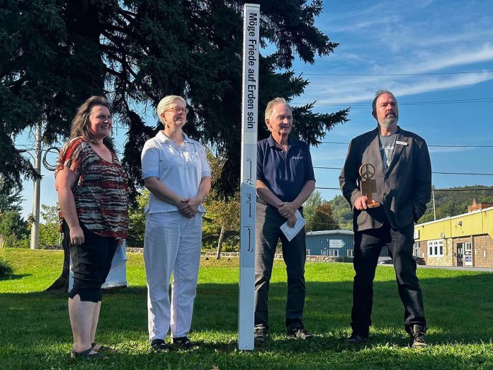 From right to left: Bancroft resident and Canadian Peace Museum founder Chris Houston, Bancroft mayor Paul Jenkins, Reverend Svinda Heinrichs of St Paul's United Church, and Bancroft general manager Andra Kauffeldt celebrated the unveiling of a peace pole in Cenotaph Park on September 20, 2024, the day before International Day of Peace. Funded by the Town of Bancroft, the peace pole is a monument that displays the message "May Peace Prevail on Earth" in eight languages, including English, French, and Algonquin. (Photo courtesy of Chris Houston)