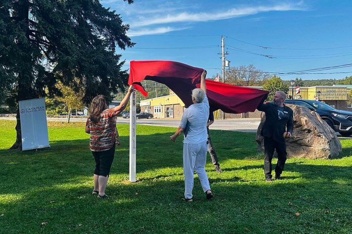 Town of Bancroft general manager Andra Kauffeldt, Reverend Svinda Heinrichs of St Paul's United Church, Bancroft resident and Canadian Peace Museum founder Chris Houston, and Bancroft mayor Paul Jenkins unveiled a peace pole in Cenotaph Park on September 20, 2024, the day before International Day of Peace. (Photo courtesy of Chris Houston)