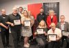 The graduates of Community Futures Peterborough's 2024 ScaleUP program, presented in partnership with Scotiabank, were celebrated during an event on September 17, 2024 at Venture North in downtown Peterborough. Pictured from left to right, front and back: Braden Clark of Community Futures Peterborough, Clint Clarke of Barking Pixel Design Co., Tracy Cosburn of Kyoto Coffee, Alicia Doris of Living Local Marketplace, Jacob Rodenburg of Camp Kawartha, Sean Flanagan of Flanagan and Sun, Peterborough city councillor Don Vassiliadis, Diane Richard of Diatom Consulting, Kevin Miller of Scotiabank, and Peterborough County warden Bonnie Clark. (Photo: Jeannine Taylor / kawarthaNOW)