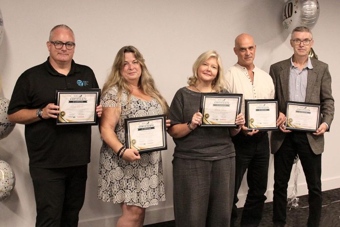 The graduates of the 2024 ScaleUP program: Clint Clarke of Barking Pixel Design Co., Tracy Cosburn of Kyoto Coffee, Alicia Doris of Living Local Marketplace, Jacob Rodenburg of Camp Kawartha, and Sean Flanagan of Flanagan and Sun. Not pictured: Debra Ragbar of Kawartha Spice Company. (Photo: Jeannine Taylor / kawarthaNOW)