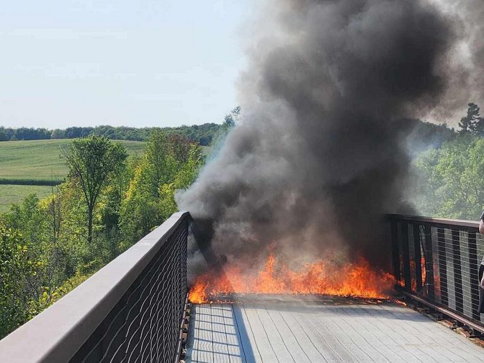 A fire on the decking of Doube's Trestle Bridge along the Kawartha Trans Canada Trail between Peterborough and Omemee on September 4, 2024. (Photo: WS via Facebook)