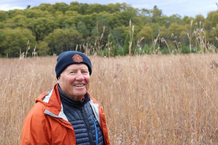 Land donor Ralph McKim, pictured Kawartha Land Trust's Ballyduff Trails in 2022, has been working to restore the tallgrass prairie for over 15 years. In 2022 he and Jean Garsonnin donated their property to Kawartha Land Trust to ensure its permanent protection. Seeds collected by volunteers during the annual tallgrass and wildflower seed harvest on October 6, 2024 will be used to help restore the prairie. (Photo: Dani Couture / Kawartha Land Trust)