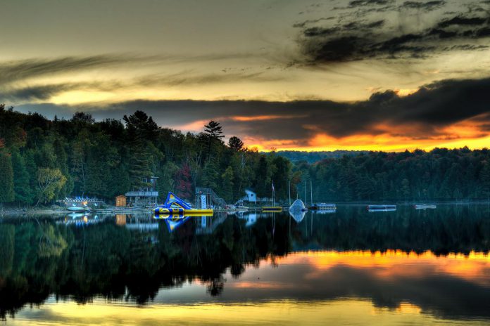 Located near the southern boundary of Canada's famous Algonquin Park, Camp Timberlane sits on 1,100 acres on the edge of a private lake, and offers everything from paddle sports and sandy beaches to a sauna and high ropes course. The Women Build Retreat hosted by the Habitat for Humanity Peterborough & Kawarthas Region and Women's Business Network of Peterborough from October 4 - 6, 2024 will give participating women the opportunity to enjoy the fall colours while unwinding, engaging in fun activities, and learning construction skills, all while supporting affordable home ownership in Haliburton. (Photo: Camp Timberlane)