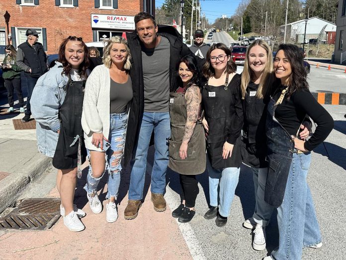 Chloe Dewhurst (far right) with her staff at downtown Millbrook's ReThink Hair posing alongside Alan Ritchson, who plays Jack Reacher in the Amazon Prime action-thriller "Reacher." The actor was in Millbrook this summer filming an episode for the third season of the show, one of many productions that have and will be filmed in Millbrook. (Photo courtesy of Millbrook BIA)