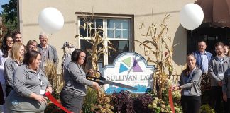 Martha Sullivan of Sullivan Law Ptbo in downtown Peterborough cuts a ribbon on September 19, 2024 to officially mark the law firm's move last October to its larger and renovated location on Queen Street and to celebrate its recent B Corporation certification. Sullivan Law Ptbo is just the sixth Canadian law firm to receive the certification, and only the second in Ontario. (Photo: Jeannine Taylor / kawarthaNOW)