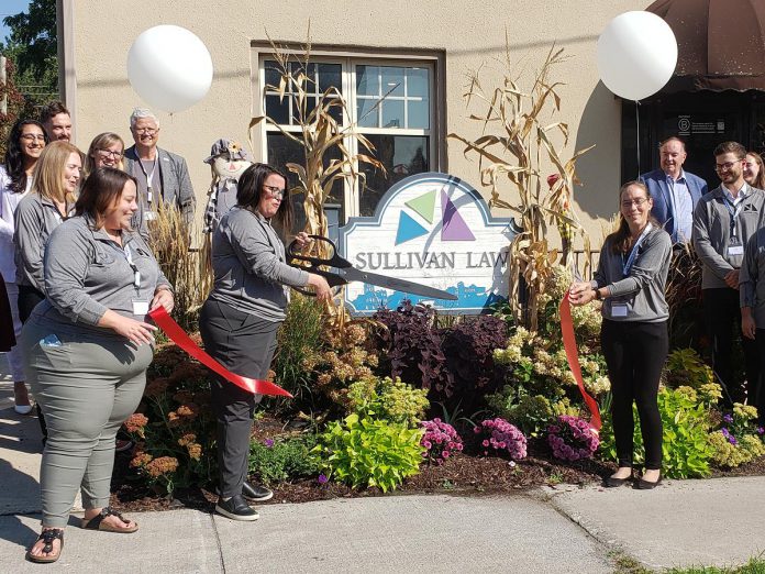 Martha Sullivan of Sullivan Law Ptbo in downtown Peterborough cuts a ribbon on September 19, 2024 to officially mark the law firm's move last October to its larger and renovated location on Queen Street and to celebrate its recent B Corporation certification. Sullivan Law Ptbo is just the sixth Canadian law firm to receive the certification, and only the second in Ontario. (Photo: Jeannine Taylor / kawarthaNOW)