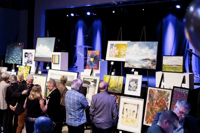 Bidders gather around artworks during the 2023 It's All About ART fundraising auction held by the Art Gallery of Peterborough at The Venue in downtown Peterborough. The 2024 fundraiser in support of the gallery's programming returns with a live in-person auction on Saturday, October 26 and an online silent auction running from October 11 to 26. (Photo: Zach Ward)