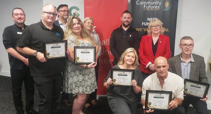 The graduates of Community Futures Peterborough's 2024 ScaleUP program, presented in partnership with Scotiabank, were celebrated at Venture North in downtown Peterborough on September 17, 2024 at Venture North. Pictured from left to right, front and back: Clint Clarke of Barking Pixel Design Co., Tracy Cosburn of Kyoto Coffee, Alicia Doris of Living Local Marketplace, Jacob Rodenburg of Camp Kawartha, Braden Clark of Community Futures Peterborough, Peterborough city councillor Don Vassiliadis, Diane Richard of Diatom Consulting, Kevin Miller of Scotiabank, Peterborough County warden Bonnie Clark, and Sean Flanagan of Flanagan and Sun. (Photo: Jeannine Taylor / kawarthaNOW)