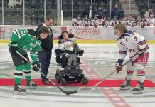 Five Counties Children's Centre CEO Scott Pepin and alumnus Nick Scarr, a huge Cobourg Cougars fan, during the puck drop before the inaugural Cougars for Kids game in 2023. Five Counties is teaming up with the Cougars again for the second annual Cougars for Kids game at the Cobourg Community Centre on November 16, 2024. Funds raised from the game will support treatment services for children and youth with special needs in Northumberland County. (Photo: Five Counties Children's Centre)