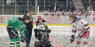 Five Counties Children's Centre CEO Scott Pepin and alumnus Nick Scarr, a huge Cobourg Cougars fan, during the puck drop before the inaugural Cougars for Kids game in 2023. Five Counties is teaming up with the Cougars again for the second annual Cougars for Kids game at the Cobourg Community Centre on November 16, 2024. Funds raised from the game will support treatment services for children and youth with special needs in Northumberland County. (Photo: Five Counties Children's Centre)