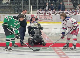 Five Counties Children's Centre CEO Scott Pepin and alumnus Nick Scarr, a huge Cobourg Cougars fan, during the puck drop before the inaugural Cougars for Kids game in 2023. Five Counties is teaming up with the Cougars again for the second annual Cougars for Kids game at the Cobourg Community Centre on November 16, 2024. Funds raised from the game will support treatment services for children and youth with special needs in Northumberland County. (Photo: Five Counties Children's Centre)