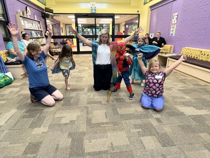 Five Counties Children's Centre clinicians Katie (far left) and Ange (centre) and the kids attending the Heel-Toe Express Group demonstrate their super powers for all to see. Weekly themes were organized to make the physiotherapy program "fun" for kids, including this session where everyone dressed up as superheroes. (Photo courtesy of Five Counties Children's Centre)