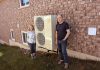 Peterborough residents Michael and Norma Doran pose with their heat pump, which they installed in 2023. The Dorans worked with GreenUP's home energy team to evaluate their home's efficiency, and were able to take advantage of an incentive program to upgrade their home. You can learn more about heat pumps and other energy-saving solutions, incentive programs, and more at the Home Energy Expo on October 19, 2024 at the McDonnel St. Activity Centre in Peterborough. (Photo: Clara Blakelock / GreenUP)