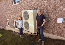 Peterborough residents Michael and Norma Doran pose with their heat pump, which they installed in 2023. The Dorans worked with GreenUP's home energy team to evaluate their home's efficiency, and were able to take advantage of an incentive program to upgrade their home. You can learn more about heat pumps and other energy-saving solutions, incentive programs, and more at the Home Energy Expo on October 19, 2024 at the McDonnel St. Activity Centre in Peterborough. (Photo: Clara Blakelock / GreenUP)