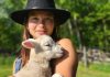 Beatrice Chan, the new program coordinator of the Net Zero Farms program, with one of her lambs from her farm in Selwyn Township where she farms sheep, cut flowers, meat chickens, and runs a flock of layers as well. She is looking forward to working with other local farmers in her new role as coordinator. (Photo: Bea Chan)