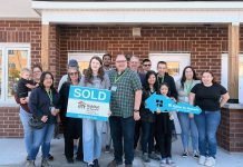 Through Habitat for Humanity Peterborough & Kawartha Region (Habitat PKR), 12 families (including Derrick and his daughter Maelyn, holding the sold sign) have achieved affordable homeownership of units at 21 Leahy's Lane in Peterborough. The non-profit organization held a dedication ceremony on October 20, 2024, that was attended by the families, dignitaries, project partners, and supporters. (Photo courtesy of Habitat PKR)