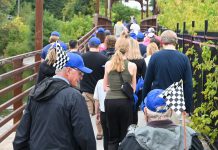 Participants in the annual Hike for Hospice fundraiser for Hospice Peterborough cross the bridge from Millennium Park on their way to Roger's Cove in East City on September 22, 2024. (Photo: Anne Leavens)