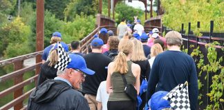 Participants in the annual Hike for Hospice fundraiser for Hospice Peterborough cross the bridge from Millennium Park on their way to Roger's Cove in East City on September 22, 2024. (Photo: Anne Leavens)