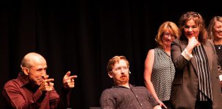 Kerry Griffin performs an unconventional kind of therapy on Mark Rostrup as Janet Van Der Graaff, Linda Kash, and Naomi Snieckus look on during klusterfork's "School's Out!" improv show at the Market Hall in July 2023. Griffin and Van Der Graaff are two of the improv professionals who will perform in klusterfork's "Impros vs. Joes" improv comedy show at the Gordon Best Theatre in downtown Peterborough on November 15, 2024, along with klusterfork's "Keep Me Up" improv workshop students. (Photo: Andy Carroll)