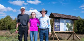 Dan Roussel, Marlene Roussel, and Mike Roussel after planting a ceremonial burr oak on September 27, 2024 to mark the opening of Kawartha Land Trust's Roussel-Steffler Memorial Forest, located within the Roussel-Steffler Memorial Sanctuary. The Roussel-Steffler family donated their 102-acre property to Kawartha Land Trust for protection in 2023 in honour of their late husband and father Paul Roussel. (Photo: Stephanie Lake for Kawartha Land Trust)