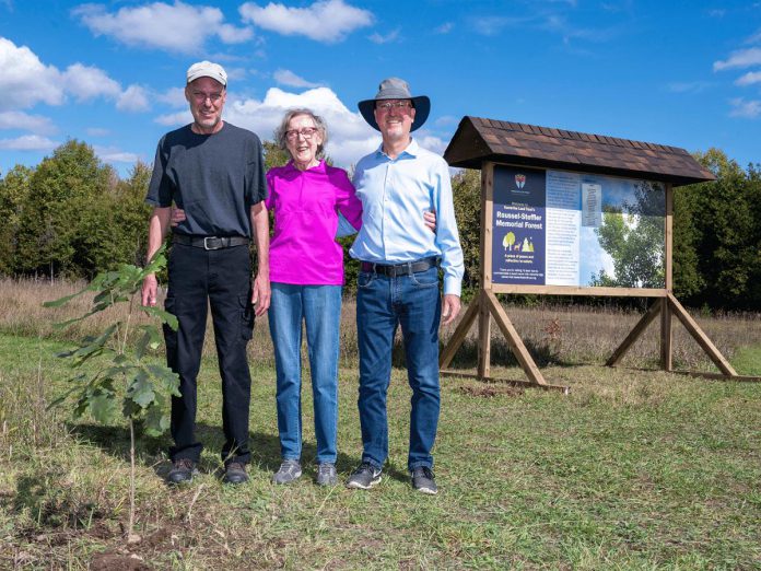 Dan Roussel, Marlene Roussel, and Mike Roussel after planting a ceremonial burr oak on September 27, 2024 to mark the opening of Kawartha Land Trust's Roussel-Steffler Memorial Forest, located within the Roussel-Steffler Memorial Sanctuary. The Roussel-Steffler family donated their 102-acre property to Kawartha Land Trust for protection in 2023 in honour of their late husband and father Paul Roussel. (Photo: Stephanie Lake for Kawartha Land Trust)