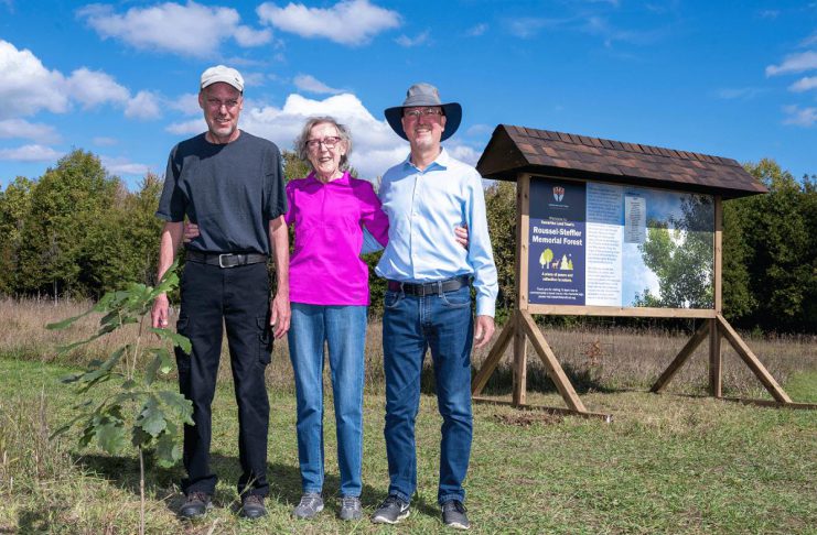 Dan Roussel, Marlene Roussel, and Mike Roussel after planting a ceremonial burr oak on September 27, 2024 to mark the opening of Kawartha Land Trust's Roussel-Steffler Memorial Forest, located within the Roussel-Steffler Memorial Sanctuary. The Roussel-Steffler family donated their 102-acre property to Kawartha Land Trust for protection in 2023 in honour of their late husband and father Paul Roussel. (Photo: Stephanie Lake for Kawartha Land Trust)