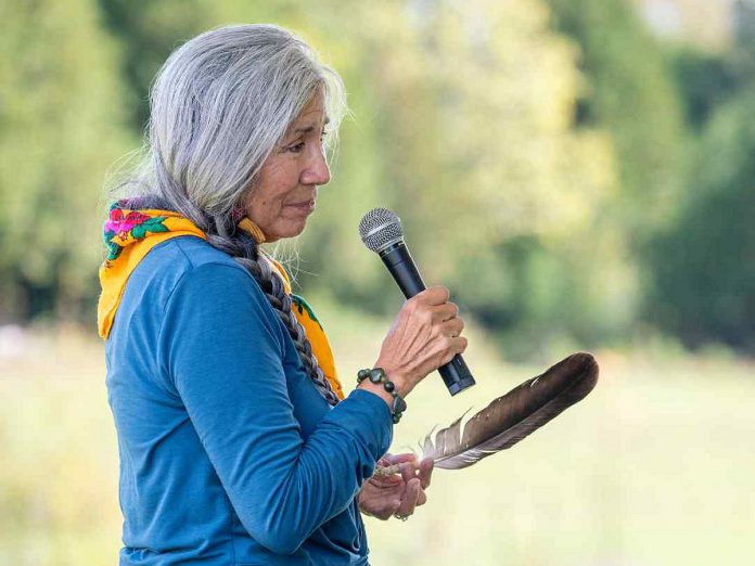 Mary Anne Caibaiosai, a knowledge keeper originally from Wiikwemkoong unceded territory (Manitoulin Island), at the opening ceremony of Kawartha Land Trust's Roussel-Steffler Memorial Forest on September 27, 2024. The Roussel-Steffler Memorial Forest sign, which will feature the names of donors' loved ones, was unveiled at the ceremony where Caibaiosai spoke about connecting to those who have passed through nature and the nature of grief.  (Photo: Stephanie Lake for Kawartha Land Trust)