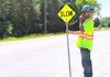 A road construction worker in Peterborough County. (kawarthaNOW screenshot of Peterborough County video)