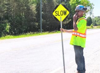 A road construction worker in Peterborough County. (kawarthaNOW screenshot of Peterborough County video)