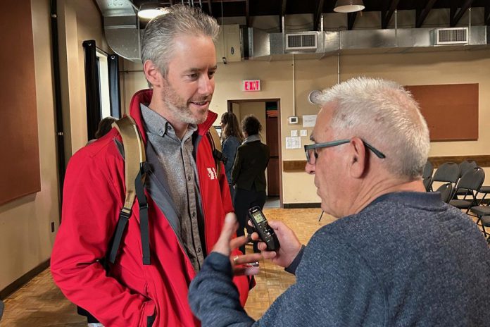 kawarthaNOW writer Paul Rellinger speaks to New Canadians Centre executive director Andy Cragg during an event at the Peterborough Theatre Guild on October 23, 2024, where representatives of some of the local charitable organizations that have recently received grants from the Peterborough Foundation gathered to share stories of how they have used the grants. (Photo: Mike Melnick)