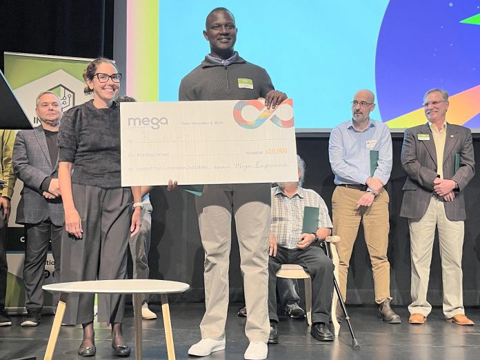 As runner-up of the Innovation Cluster's LevelUP Pitch Competition at Market Hall Performing Arts Centre in downtown Peterborough on November 6, 2024, Kinen Ocitti of Kuwota received a branding package from Peterborough-based Mega Experience Inc. valued at $10,000, provided by Peterborough-based Mega Experience Inc. Kuwota is an AI-powered application supporting mental health that allows users to journal and share their entries confidentially with licensed therapists. (Photo courtesy of Innovation Cluster)