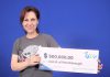 Peterborough artist Lisa Martini-Dunk with her $500,000 in winnings from the Lotto Max draw on October 15, 2024. She purchased her winning ticket online. (Photo: OLG)