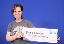 Peterborough artist Lisa Martini-Dunk with her $500,000 in winnings from the Lotto Max draw on October 15, 2024. She purchased her winning ticket online. (Photo: OLG)