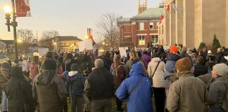 Around 400 people gathered outside Peterborough City Hall on November 12, 2024 to protest a proposed 25 per cent across-the-board cut in the City of Peterborough's 2025 draft budget to grants to community organizations. (Photo: Paul Rellinger / kawarthaNOW)