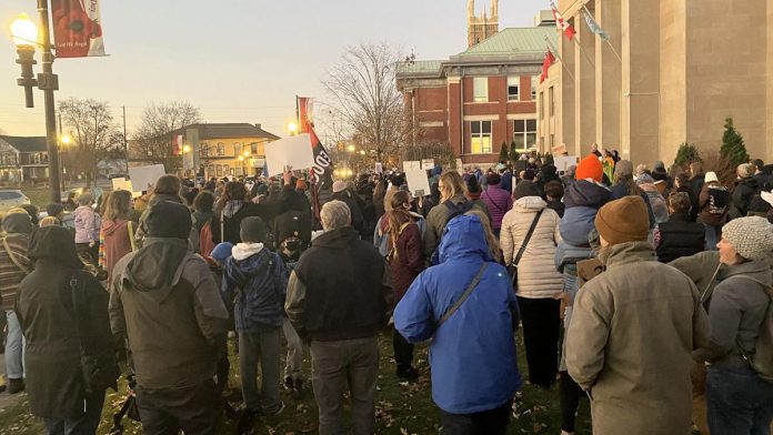 Around 400 people gathered outside Peterborough City Hall on November 12, 2024 to protest a proposed 25 per cent across-the-board cut in the City of Peterborough's 2025 draft budget to grants to community organizations. (Photo: Paul Rellinger / kawarthaNOW)