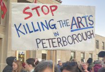 Supporters of local arts and social services organizations gathered outside Peterborough City Hall on November 12, 2024 to protest a proposed 25 per cent across-the-board cut in the City of Peterborough's 2025 draft budget to grants to community organizations. (Photo: Paul Rellinger / kawarthaNOW)