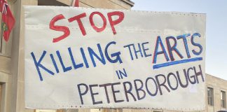 Supporters of local arts and social services organizations gathered outside Peterborough City Hall on November 12, 2024 to protest a proposed 25 per cent across-the-board cut in the City of Peterborough's 2025 draft budget to grants to community organizations. (Photo: Paul Rellinger / kawarthaNOW)