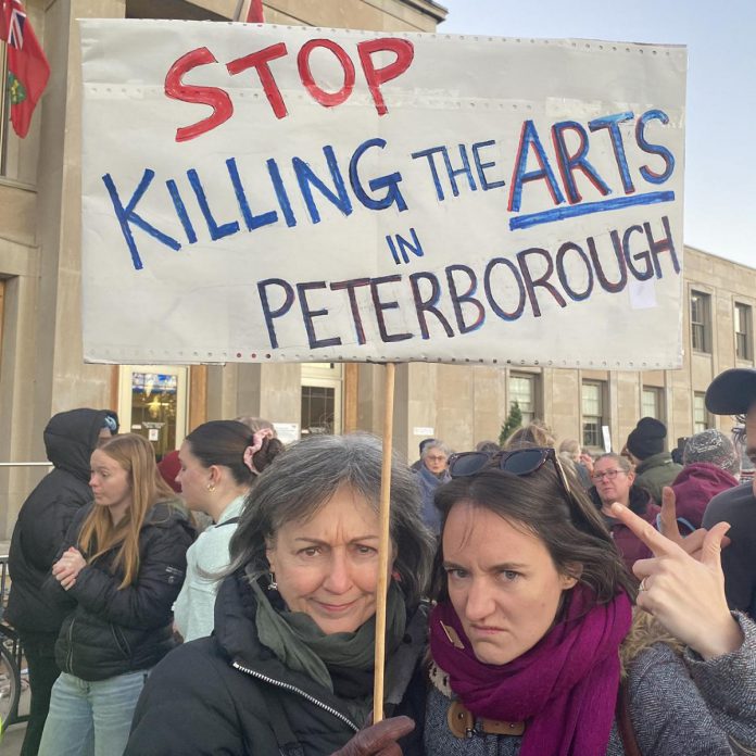 Supporters of local arts and social services organizations gathered outside Peterborough City Hall on November 12, 2024 to protest a proposed 25 per cent across-the-board cut in the City of Peterborough's 2025 draft budget to grants to community organizations. (Photo: Paul Rellinger / kawarthaNOW)